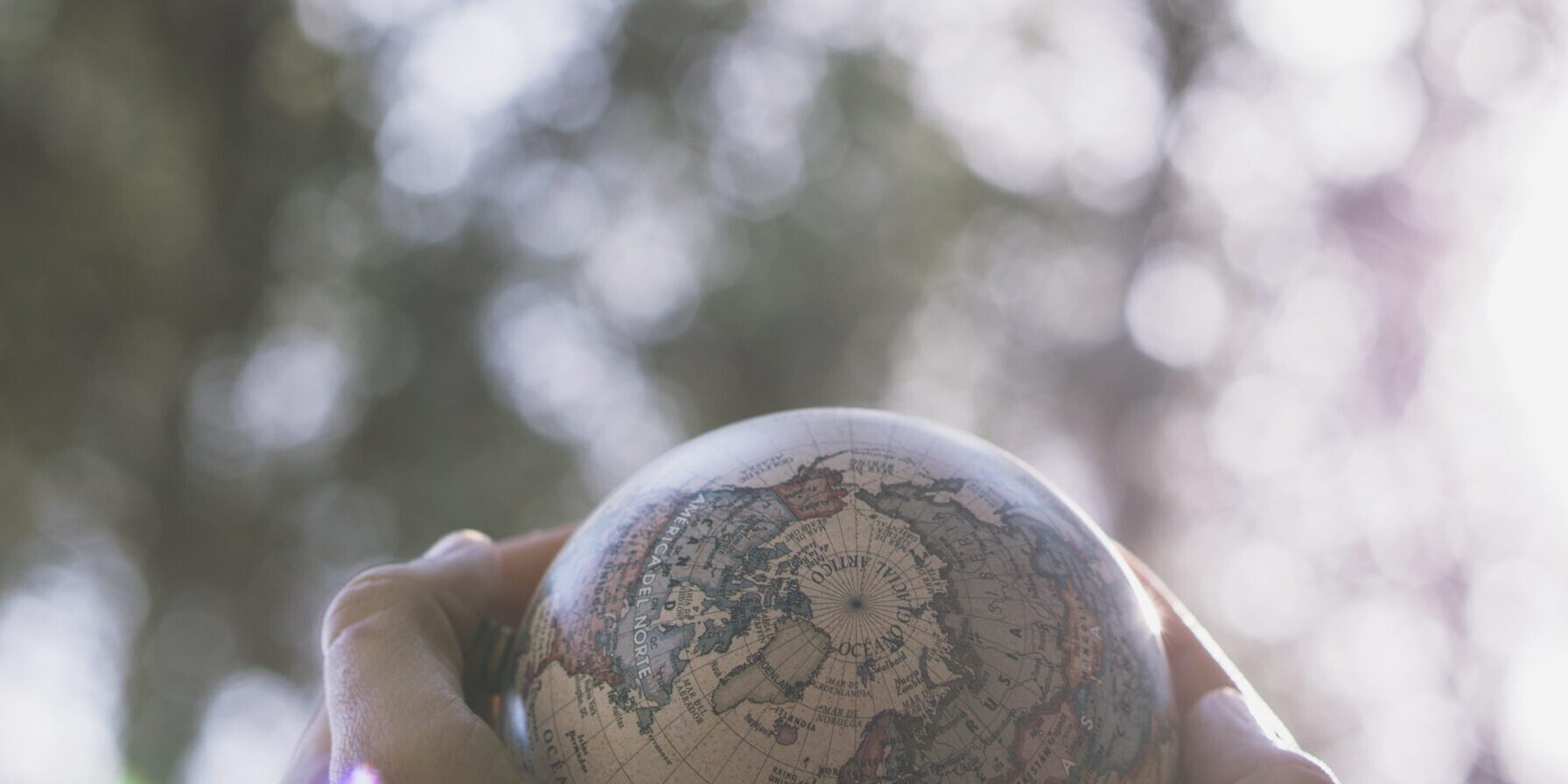crop-hands-with-small-globe-nature